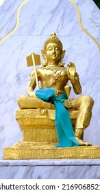 Vishnu Statue Gold Color With Blue Background.