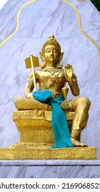 Vishnu Statue Gold Color With Blue Background.