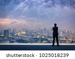 Vision concept. Successful businessman standing with hands crossed on chest, On top of building and looking through Cityscape Skyline Night Light.