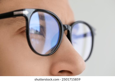 Vision correction. Man wearing glasses on blurred background, closeup - Powered by Shutterstock