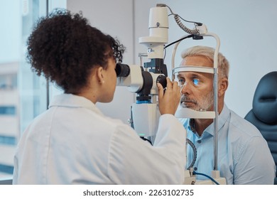 Vision, eye exam and healthcare with a doctor woman or optometrist testing the eyes of a man patient in a clinic. Hospital, medical or consulting with a female eyesight specialist and senior male - Shutterstock ID 2263102735