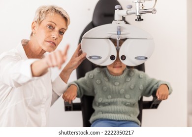 Vision, Eye And Test With A Child At Optometry Exam With A Specialist Doctor In A Clinic For Glasses. Ophthalmology, Optometry And Medical Expert Eye Test With Little Girl For Eye Health And Eye Care