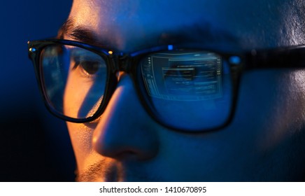 Vision, Hacking And Technology Concept - Close Up Of Hacker Eyes In Glasses Looking At Computer Screen In Darkness