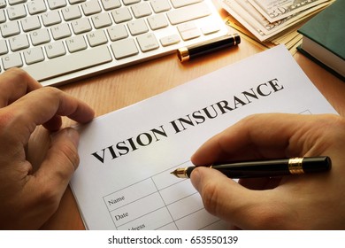 Vision Insurance Policy On A Office Table.