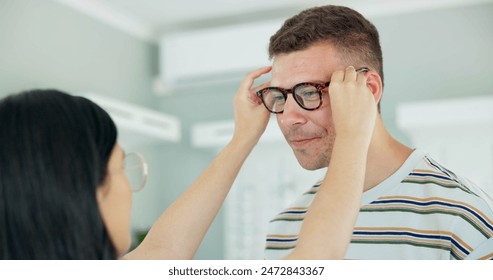 Vision, optometrist and help client with glasses for eye health, wellness or care. Ophthalmology, lens or woman fitting man with frame choice of spectacles for eyesight correction of customer at shop - Powered by Shutterstock