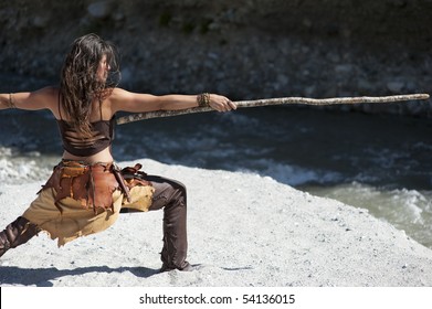 Vision Quest. Woman In Tribal Style Practicing Self Defense With A Longstick.