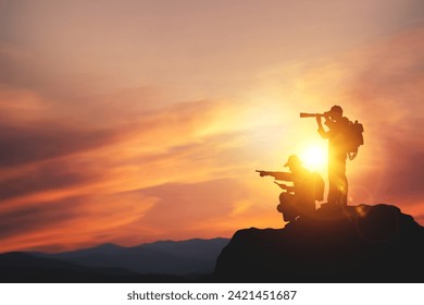 Vision for success ideas. businessman's perspective for future planning. Silhouette of man holding binoculars on mountain peak against bright sunlight sky background. - Powered by Shutterstock