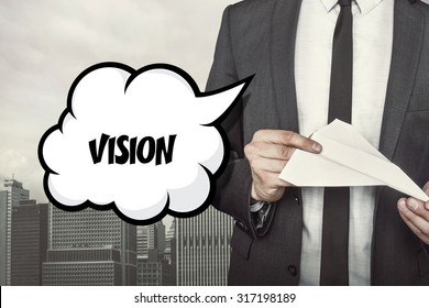Vision text on speech bubble with businessman holding paper plane in hand on city background - Shutterstock ID 317198189
