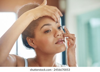 Vision, woman and contact lens in bathroom in home for health, wellness and eyesight on morning routine. Ophthalmology, corrective beauty and girl apply eyewear for medical optometry and eye care - Powered by Shutterstock