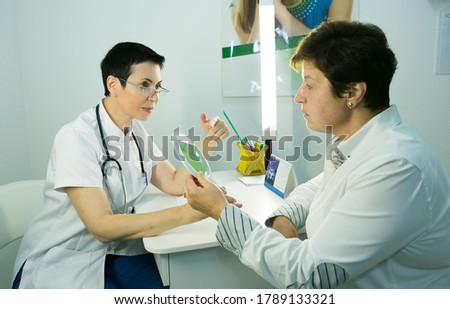 Female doctor filling out questionnaire to a senior patient