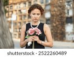 Visit to cemetery, woman in mourning clothes grieves for deceased relative. Near grave widow grieves and prays for soul of deceased relative, moment of remembrance, to pay tribute to memory