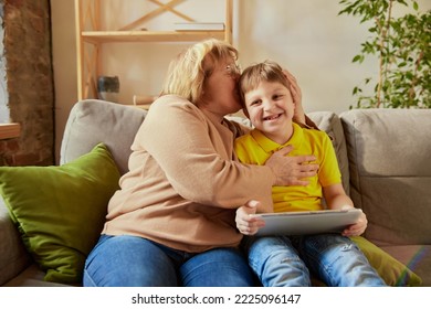 Visit Grandparent. Middle Age Woman And School Age Boy, Granny And Grandson Sitting At Home And Talking, Having Fun. Concept Of Emotions, Family, Happiness, Care, Support And Leisure Activities