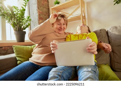 Visit Grandparent. Middle Age Woman And School Age Boy, Granny And Grandson Sitting At Home And Talking, Having Fun. Concept Of Emotions, Family, Happiness, Care, Support And Leisure Activities