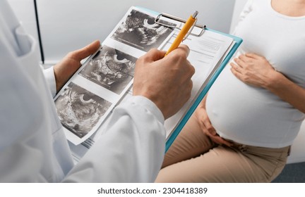 Visit to obstetrician gynecologist by pregnant woman for scheduled check-up. Pregnancy consultant - Powered by Shutterstock