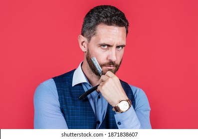 Visit your barber regularly. Serious barber hold straight razor at beard. Retro barbershop. Hair salon. Grooming and barbering. Haircare and skincare. - Powered by Shutterstock