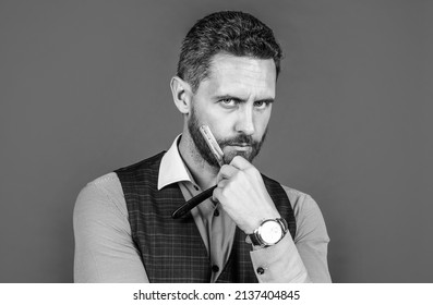 Visit your barber regularly. Serious barber hold straight razor at beard. Retro barbershop. Hair salon. Grooming and barbering. Haircare and skincare - Powered by Shutterstock