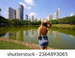 Visiting Goiania, Brazil. Rear view of beautiful girl in Parque Sulivan Silvestre also known as Parque Vaca Brava, a city park in Goiania, Goias, Brazil.