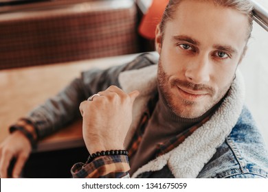 Visiting Interesting Coffee Houses. Top Angle Close Up Portrait Of Attractive Smiling Hipster Male Sitting In Retro Cafe Bus And Looking Straight On Camera