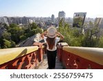 Visiting Santiago de Chile. Back view of young traveler woman on Cerro Santa Lucia hill enjoying cityscape of Santiago de Chile, South America.