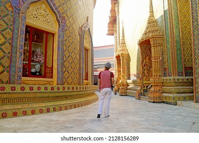 Visitor Walking Along the Circular Pagoda's Base in Wat Ratchabophit Buddhist Temple, Historic Place in Bangkok, Thailand