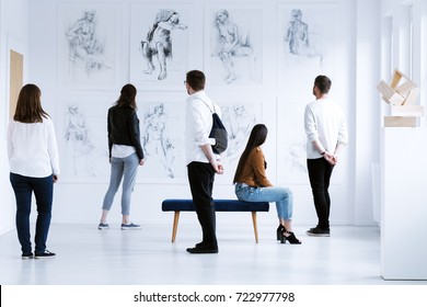 Visitors In Art Gallery With Drawings And Sculpture During Cultural Meeting. Art Gallery Concept 