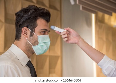 Visitors must go through fever measures using infrared  digital thermometer check temperature measurement, fever examination
at the building.Measures to prevent people with fever, Covid 19 concept - Shutterstock ID 1664640304
