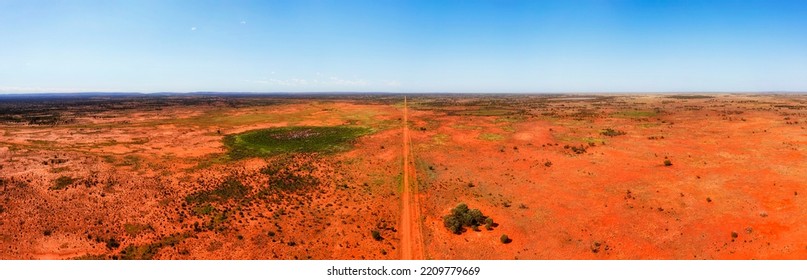 Vista Of Empty Red Soil Arid Desert Of Outback In Australia Along Barrier Highway To Broken Hill - Wide Aerial Panorama.