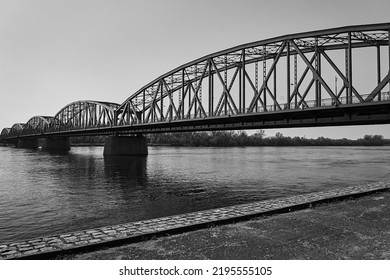 The Vistula River And The Steel Structure Of The Road Bridge In The City Of Torun, Poland, Monochrome