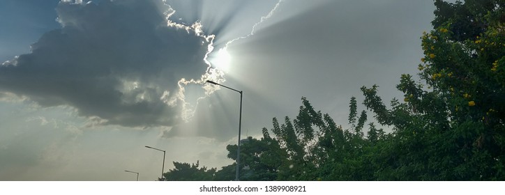 A visual delight: Sun breaking through patches of dark clouds on a late afternoon