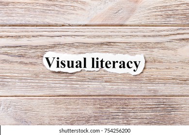 Visual Literacy Of The Word On Paper. Concept. Words Of Avisual Literacy On A Wooden Background.