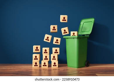 Visual metaphor of mass layoffs and redundancies, human resources concept. Dismiss from employment. Wooden cubes with employees represented by symbols and garbage can. - Shutterstock ID 2258910473