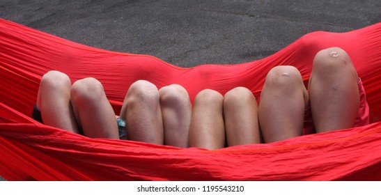 Visual Pun Boys Knees Look Like Teeth In Red Hammock