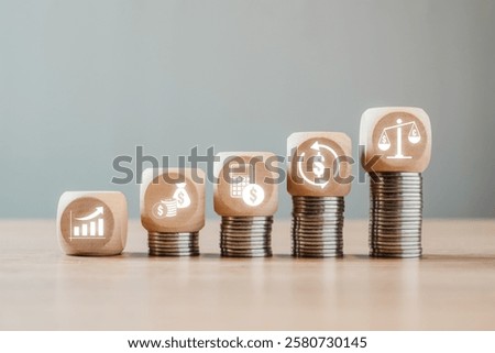 Visual representation of financial statements using coins and wooden blocks symbolizing growth, investment, and balance.