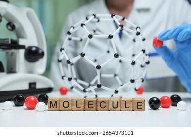 A visual representation of a molecule model being studied in a laboratory setting, typically with a microscope