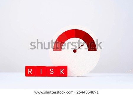 A visual representation of risk measurement, featuring a gauge and blocks spelling 'RISK' against a minimalist background.