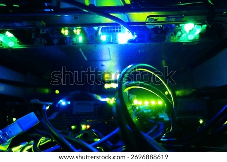 Visual representation of a server room filled with illuminated fiber optic cables and glowing lights, showcasing the complexity of modern technology and data networks.
