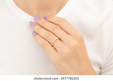 Visual of women's jewelry concept. Showing female face with colorful nail polish. Silver and gold jewelry. - Powered by Shutterstock