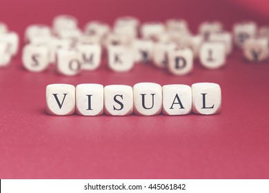 Visual Word Written On Wood Cube With Red Background