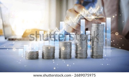 Visualize financial success with hand adding coin to stacks charting growth. Investment plan for money growth to success. Savings are crucial for investment.