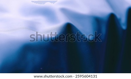 A visually appealing abstract background featuring a blue textile texture. The wavy patterns and gradient lighting create a modern and elegant look. Perfect for design projects and presentations.