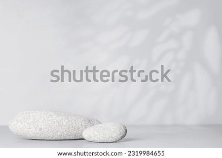 A visually appealing backdrop with smooth sea pebbles and ample copy space, perfect podium for showcasing your product