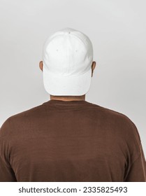 A visually appealing mockup features a man wearing a white hat, striking a simple pose, adding charm to your designs