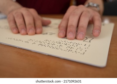 Visually Impaired Man Reading A Braille Book. 