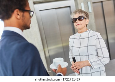 Visually Impaired Old Woman Talks To A Businessman In The Business Office