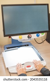 A Visually Impaired Woman Uses Special Reading Equipment