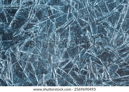 A visually striking abstract image of an ice surface reminiscent of broken glass