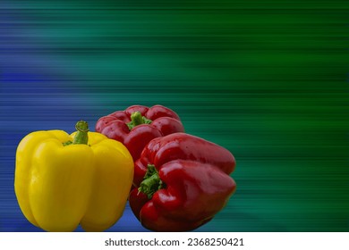 A visually striking image featuring three vibrant red and yellow sweet peppers, set against a textured background blending dark blue and green hues. The available space for text. 