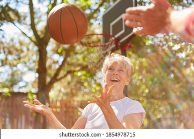 Vital Senior Woman Playing Basketball Together On The Sports Field In Summer