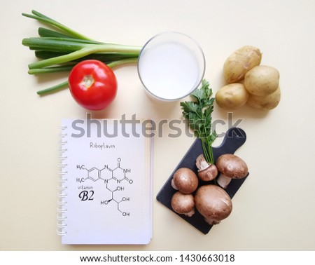 Vitamin B2 (Riboflavin). Structural chemical formula of vitamin B2 molecule with food rich in vitamin B2. Healthy food.