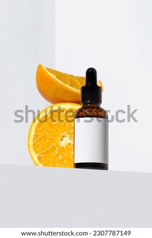 Vitamin C serum cosmetic bottle in  with oranges  on white background with copy space. Face care, beauty treatment, anti-aging, organic cosmetic industry concept. Cosmetics bottle mock up.  Foto stock © 